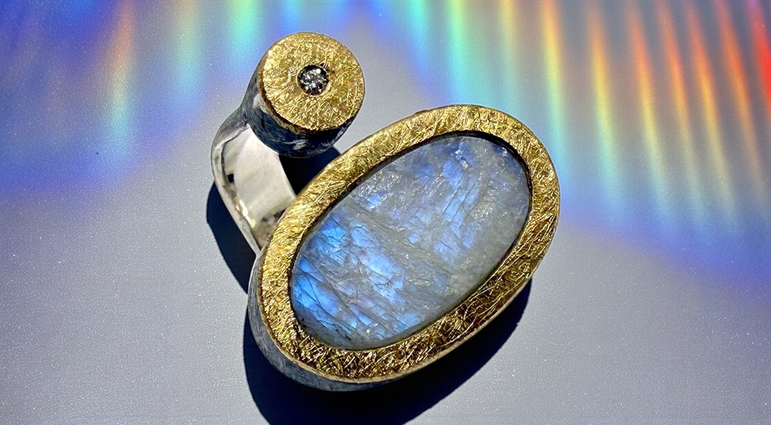 oval rough moonstone ring with diamond in silver and gold