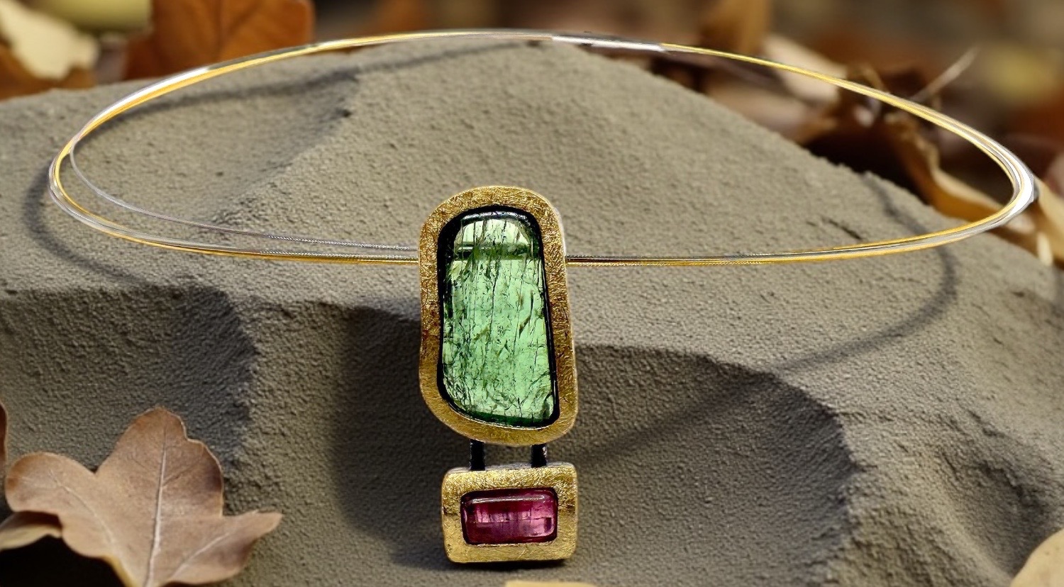 large green and pink tourmaline pendant in silver and gold